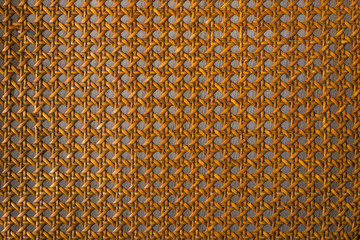 Close up of the pattern formed by open weave rattan cane