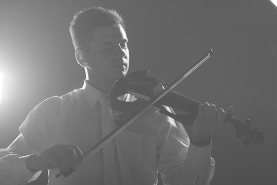 The musician plays the electronic violin. Violin close up. 