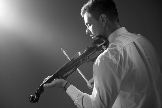 The musician plays the electronic violin. Violin close up. 