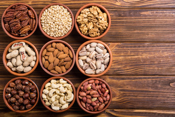 Mix of nuts : Pistachios, almonds , walnuts , pine nut , hazelnuts and cashew . Snack in bowl backgrond