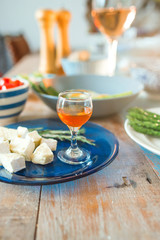 different type of cheese on the tray and cocktail