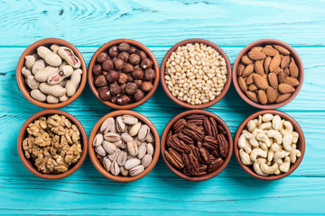 Mix of nuts : Pistachios, almonds , walnuts , pine nut , hazelnuts and cashew . Snack in bowl backgrond