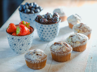 strawberry, blackberry, blueberry and muffins on the table