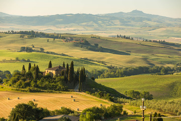 Naklejka premium A lovely farmhouse in the morhing sun, San Quirico d'Orciain, Italy