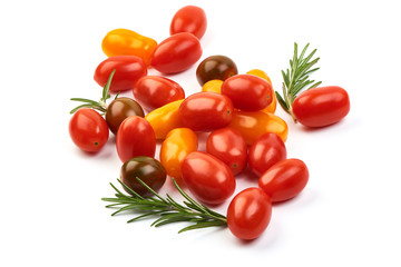 Orange, red and brown cherry Tomatoes with herbs, isolated on a white background. Close-up