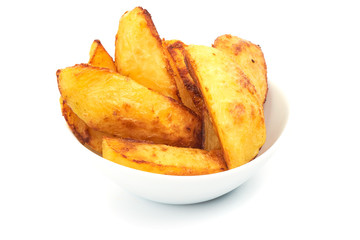 Baked Potato Wedges in a bowl, isolated on a white background. Close-up