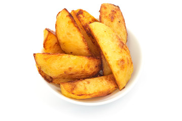American Crispy Deep fried Potato Wedges in a bowl, isolated on a white background. Close-up