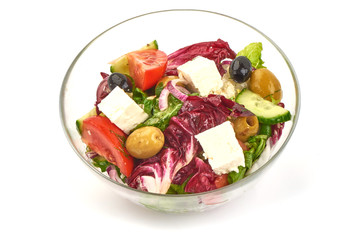 Fresh vegetable salad with feta cheese, lettuce, cherry tomatoes, olives and pepper, isolated on white background