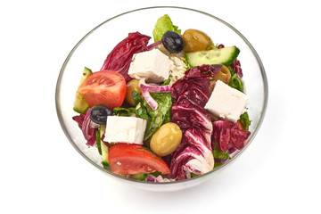 Greek salad with feta cheese, lettuce, cherry tomatoes, olives and pepper, isolated on white background.
