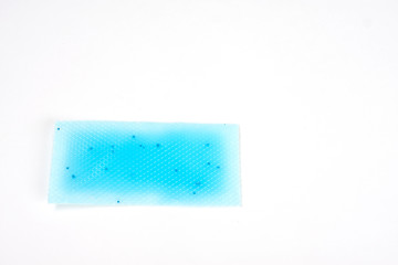 Cooling fever patch gel on hot forehead from high temperature on white background. Isolated, free space for text