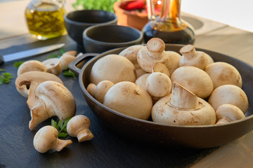 Champignon mushrooms in a cast iron skillet