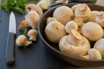 Champignon mushrooms in a cast iron skillet