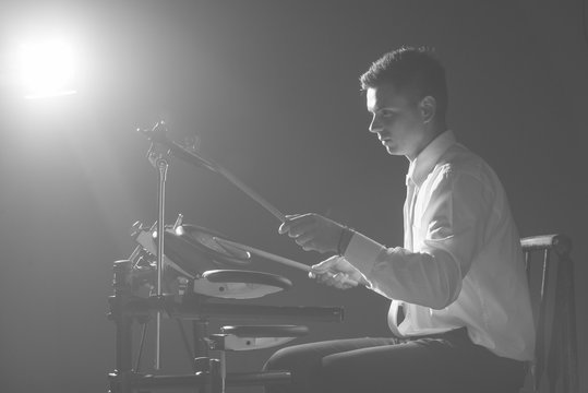 Drummer hits drum sticks