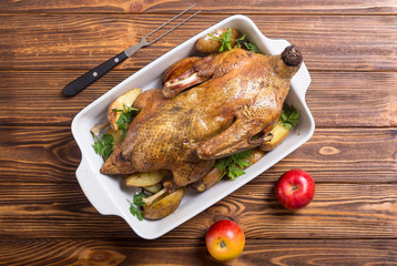 Homemade baked duck with potatoes and apple . Christmas food