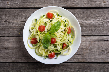 Zucchini pasta noodles with tomatoes . Healthy vegetarian food
