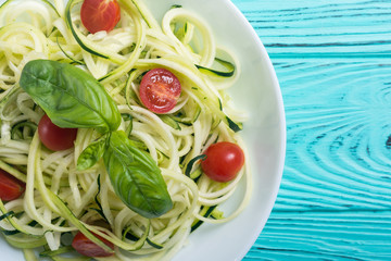 Zucchini pasta noodles with tomatoes . Healthy vegetarian food