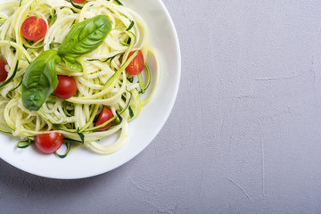 Zucchini pasta noodles with tomatoes . Healthy vegetarian food
