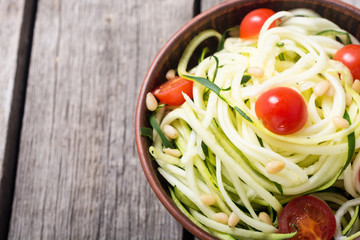 Zucchini pasta noodles with tomatoes . Healthy vegetarian food