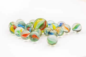 GLASS MARBLES ON WHITE BACKGROUND