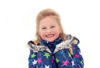 school-age girl in the winter in the snow. Portrait of happy little girl in winter outdoors. 7 year old girl has pink cheeks in the cold on white background. lifestyle and the concept of a happy child