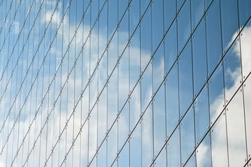 Clouds reflect in windows of modern building