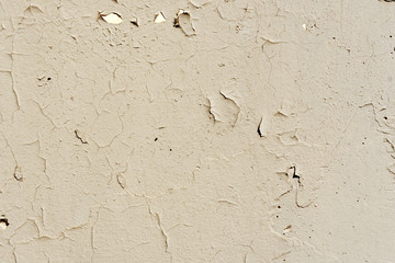 Natural background. Wall with a shabby and peeling paint, crack and plaster.  beige and yellow