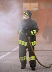 Fototapeta premium firefighter extinguishes the fire with foam