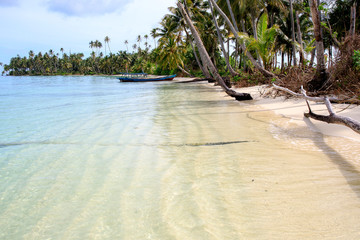A nice and empty beach in a tropical desert island of Sumatra, Indonesia. Blue sky, white sand and...