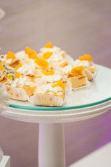 white stand with cupcakes on a candy bar table