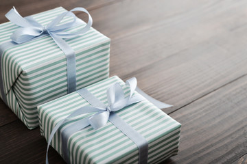 Two striped gift box with blue ribbon