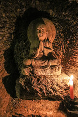 Buddha statue in the Benten-Kutsu cave shrine at the Hase-dera temple in Kamakura, Kanagawa Prefecture, Japan.