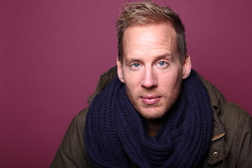 Portrait of a man in front of a colored background