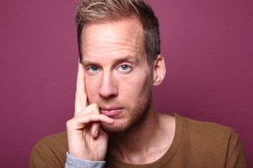 Portrait of a man in front of a colored background