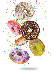 Tasty doughnuts in motion falling on pastel blue background.