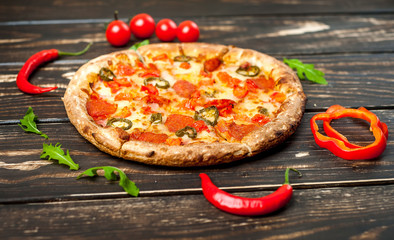 pizza on wood table with ingredients