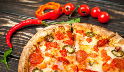 pizza on wood table with ingredients