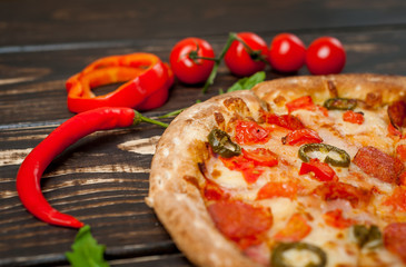 pizza on wood table with ingredients