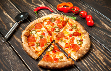 pizza on wood table with ingredients