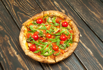pizza on wood table with ingredients