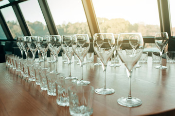 Many glasses of white and red wine stand on the bar