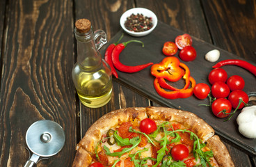 pizza on wood table with ingredients