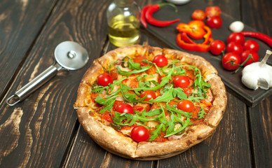 pizza on wood table with ingredients