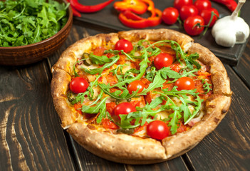 pizza on wood table with ingredients