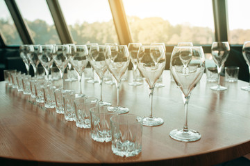 Many glasses of white and red wine stand on the bar