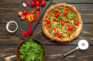 pizza on wood table with ingredients
