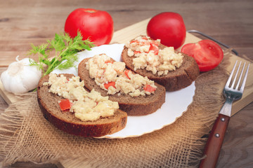 Fried eggs with tomatoes on bread. Light breakfast