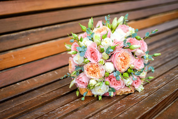 Wedding bouquet on a wooden bench