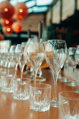 Many glasses of white and red wine stand on the bar