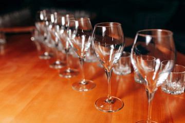 Many glasses of white and red wine stand on the bar