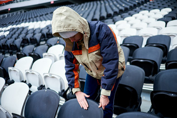Stadium employee examines places for fans